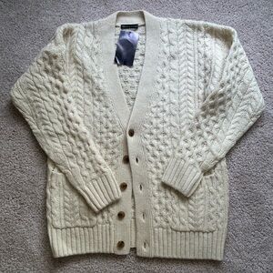 Cream cable knit cardigan.
